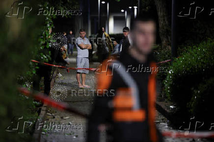 Israeli emergency services work at the scene of a missile strike, in Jaffa, south of Tel Aviv