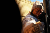 Margelis Tinoco from Colombia reacts after her appointment with CBP was canceled, in Ciudad Juarez