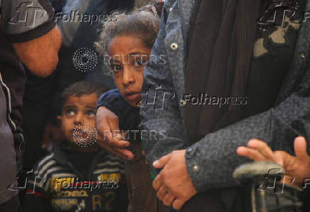 Palestinians receive aid following a ceasefire between Israel and Hamas, in Khan Younis in the southern Gaza Strip