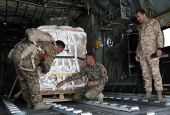 Members of Jordanian armed forces load aid parcels to be dropped over Gaza, in Zarqa