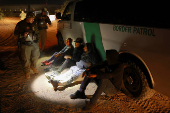 Migrants are detained by U.S. Border Patrol agents in New Mexico