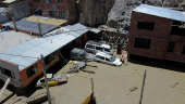 Members of Volunteer Search and Rescue Service (SAR) assist residents affected by floodings due to landslides caused by intense rains and illegal earth movements, in the Inca Llojeta area