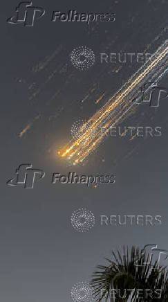 Orange balls of light fly across the sky as debris from a SpaceX rocket launched in Texas is spotted over Turks and Caicos Islands