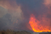 Firefighters and aircraft battle the Hughes Fire near Santa Clarita