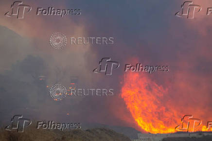 Firefighters and aircraft battle the Hughes Fire near Santa Clarita