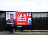 People walk past a 'Vote Labour' sign ahead of the May 2nd Blackpool South by-election