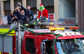 Firefighters greet people during Christmas season celebrations in Valparaiso