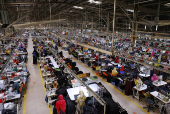 Bangladeshi garment workers sew at a textile factory in Gazipur