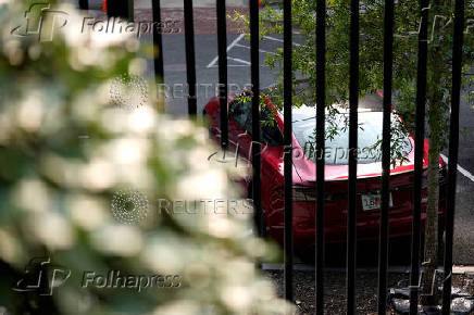 A Tesla vehicle is parked in West Executive Avenue, near the White House, in Washington