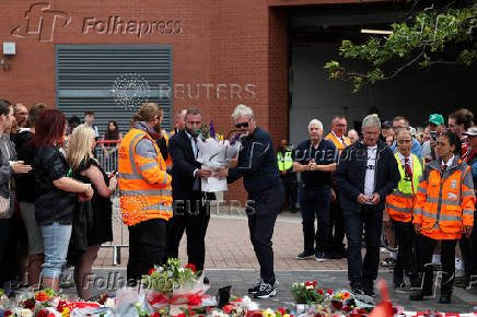 Fans pay their respects outside Anfield Stadium, on the day of the funeral of Liverpool soccer player Diogo Jota in Portugal, in Liverpool