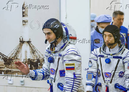 Roscosmos cosmonaut Alexey Zubritskiy and NASA astronaut Jonny Kim arrive to the spacesuit check before the launch at the Baikonur Cosmodrome