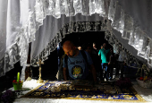 Worshippers gather for the celebrations for the Passion of the Lord at the Church of Saint Clement of Ohrid, on Good Friday, in Skopje