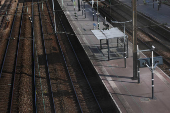 View of an empty platform and railway tracks at the Pont Cardinet train station in Paris