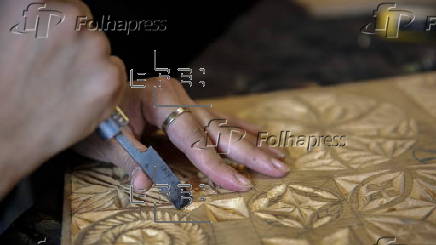 Afghan girl teach Nuristani wood carving skills at a workshop in Kabul