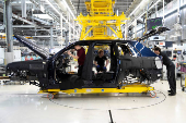 Technicians work on the assembly line for Rolls-Royce Cullinan vehicle at Rolls-Royce Motor Cars' manufacturing plant in Goodwood.