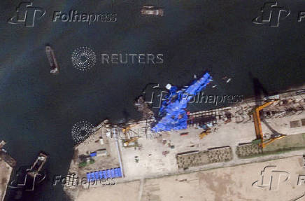A satellite image shows a North Korean warship covered with a blue tarp after an accident that occurred during its launch at the shipyard in Chongjin