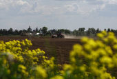 Farmers plant potatoes in a field outside Kolomna, Moscow region