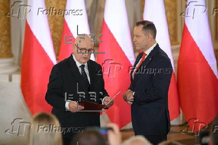 Polish President-elect Karol Nawrocki receives the winning certificate