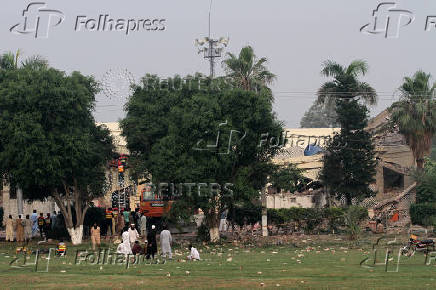 Rescuers search for survivors in a damaged building after it was hit by an Indian strike in Muridke