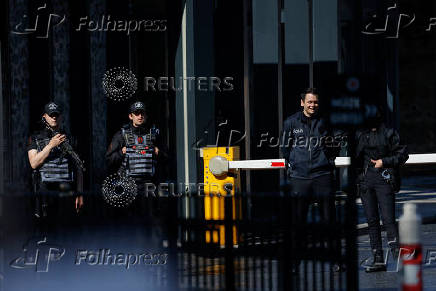 Police officers stand guard, near the Turkish Presidency's Dolmabahce working office, where Russia and Ukraine direct talks might happen, in Istanbul