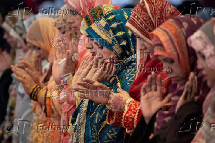 Women take part in Eid ul-Adha prayer at the Badshahi Mosque in Lahore