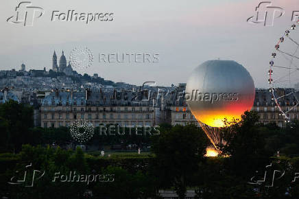 A new Paris 2024 cauldron set on a balloon is back in the Tuileries Garden and the Paris skyline