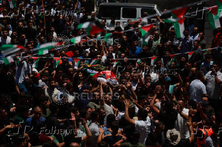 People carry the body of Mohammad Al-Shalabi, near Ramallah