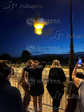 A message in support of Palestinians in Gaza is projected onto the hot air balloon holding the the Vasque (cauldron) of Paris 2024 non-Olympic flame in Paris