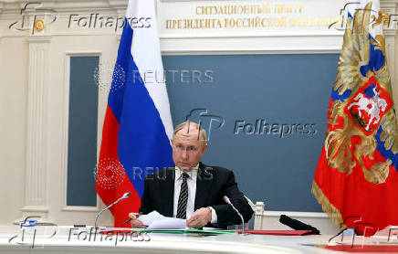 FILE PHOTO: Russian President Putin inspects an exercise to test delivering a massive retaliatory nuclear strike, via a video link from Moscow