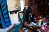 A Druze resident of Al-Soura al-Kubra, Salman Olaiwi, inspects his damaged home