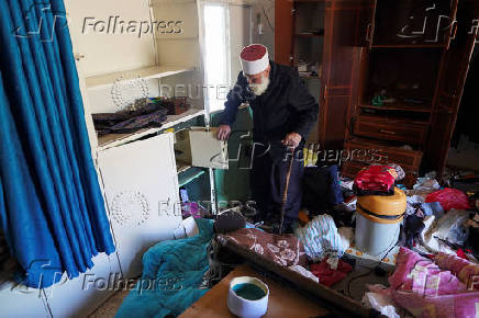 A Druze resident of Al-Soura al-Kubra, Salman Olaiwi, inspects his damaged home