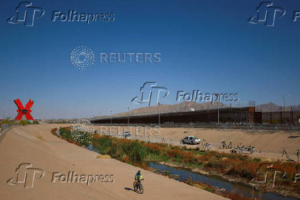 Members of the U.S. military replace concertina wire at on the U.S.-Mexico border, as seen from Ciudad Juarez