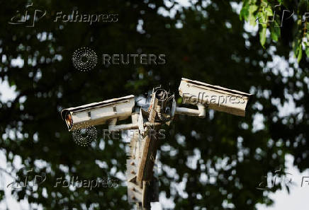 Installed closed circuit television (CCTV) cameras are seen in a street in New Delhi