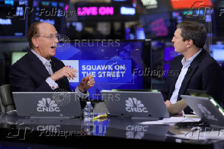 FILE PHOTO: Larry Fink, Chairman and CEO of BlackRock, speaks during an interview with CNBC on the floor at the NYSE in New York
