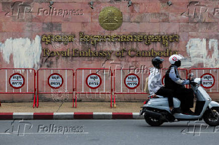 People ride a two-wheeler past the Royal Embassy of Cambodia, after Thailand has recalled its ambassador to Cambodia an expelled Cambodia's ambassador, amid border disputes in Bangkok