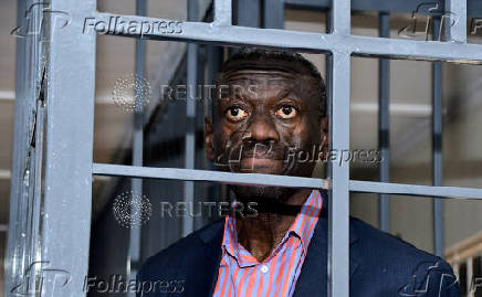FILE PHOTO: Ugandan four-time presidential aspirant Kizza Besigye stands in dock at the Uganda Military General Court Martial in Kampala