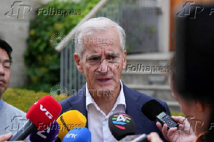 FILE PHOTO: Norwegian re-elected PM Stoere talks to media in Oslo