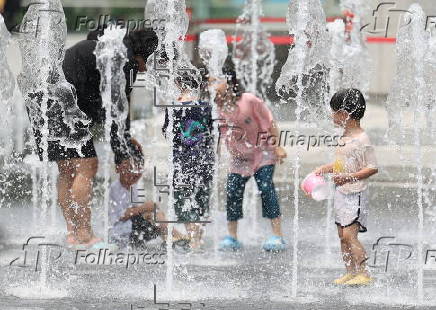 Children playing in fountain on hot day in Seoul