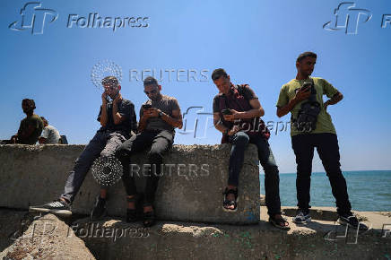 Palestinians attempt to access the internet using eSIMs, in Gaza City