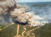 Smoke rises from wildfire SWF076, which has prompted a one-hour evacuation notice for the nearby town of Swan Hills