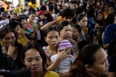 Residents affected by monsoon rains queue for relief following monsoon rains in Quezon City