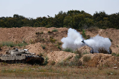 A mobile artillery unit fires towards Gaza, as seen from the Israel