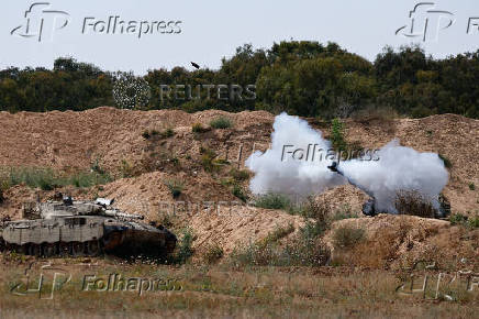 A mobile artillery unit fires towards Gaza, as seen from the Israel