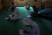 Students take a religious studies exam at a madrasa in Multan