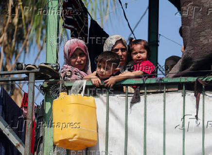 Palestinians inspect the damage following an overnight Israeli strike on a school sheltering displaced families, in Jabalia