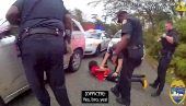 A police officer searches William McNeil Jr at an unidentified location, in Florida