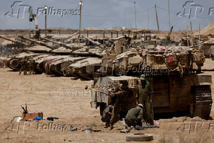 Israeli soldiers work near the Israel-Gaza border