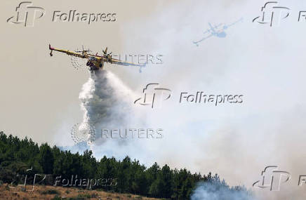 Firefighters battle a wildfire raging in Spain's Avila region