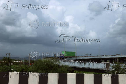 A truck transports a shipping container in Navi Mumbai