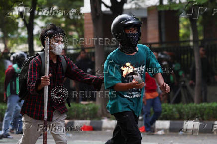 Protest outside Jakarta Mobile Brigade (Brimob) headquarters, during a clash after a motorcycle taxi driver died after being struck and run over by a police tactical vehicle, in Jakarta